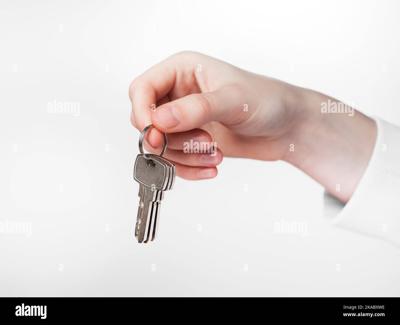 Hand holding keys on keyring over white background Stock Photo Alamy