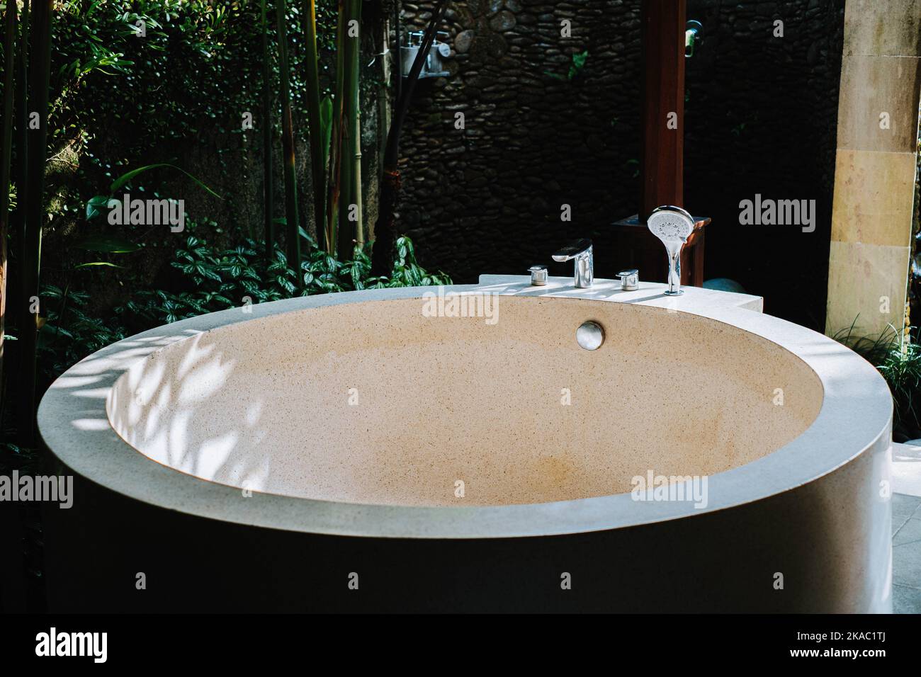 Rounded bathtub made from concrete with terrazzo finishing. It is used in villa in Ubud, Bali