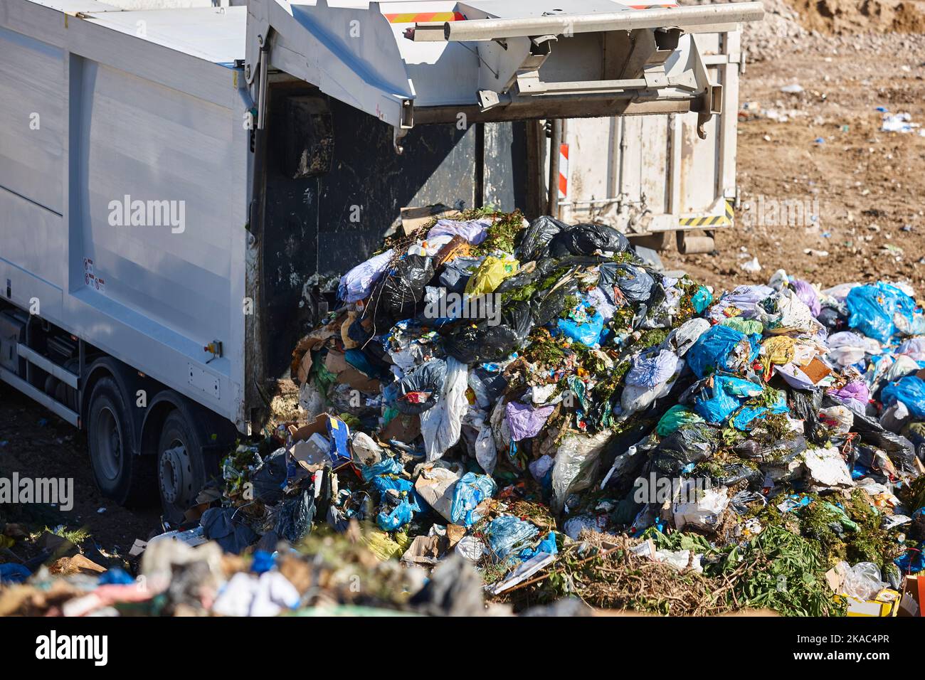 Truck unloading garbage on an open air dump. Waste recycling Stock