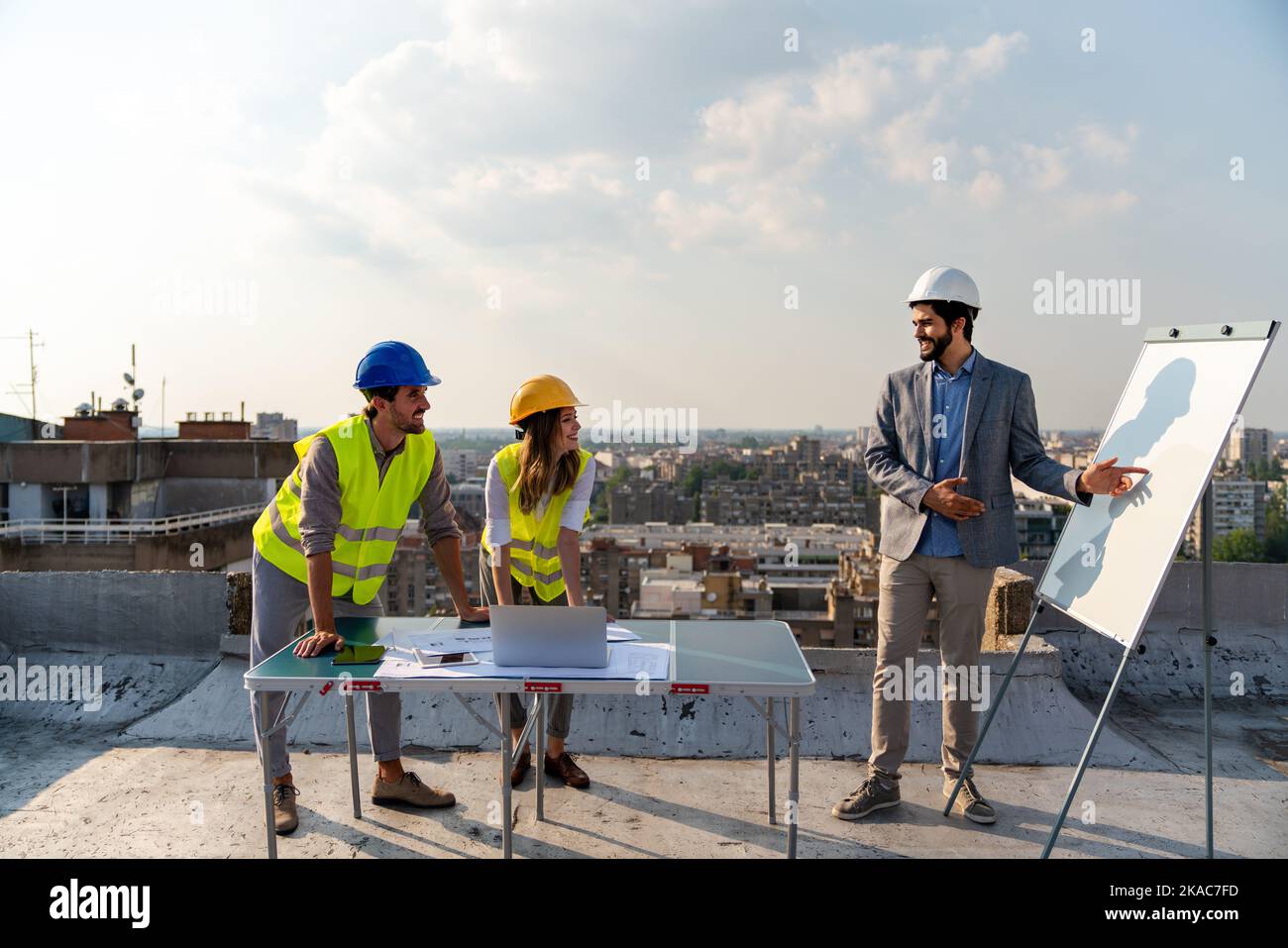 Construction concept. Engineers and architects working at construction site with blueprint Stock Photo