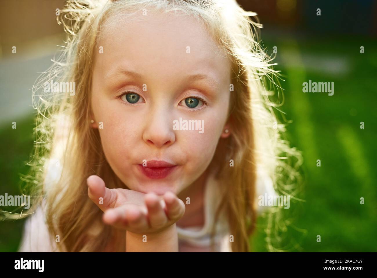 This is for you. Portrait of a cheerful little girl standing and