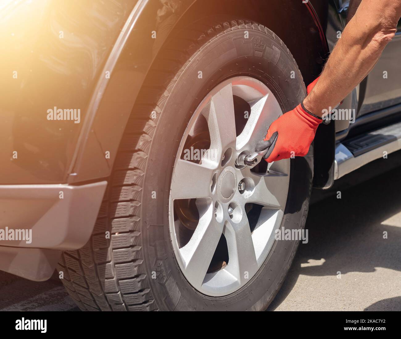 Fixing and checking wheel tire of car with manual metal tool, close up