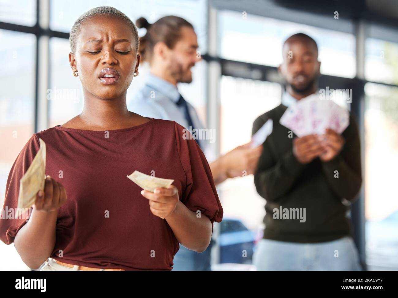 Black woman, unequal pay and confused by wages, paycheck and quote in office, frustrated and annoyed. Angry, woman and reading salary slip with happy Stock Photo