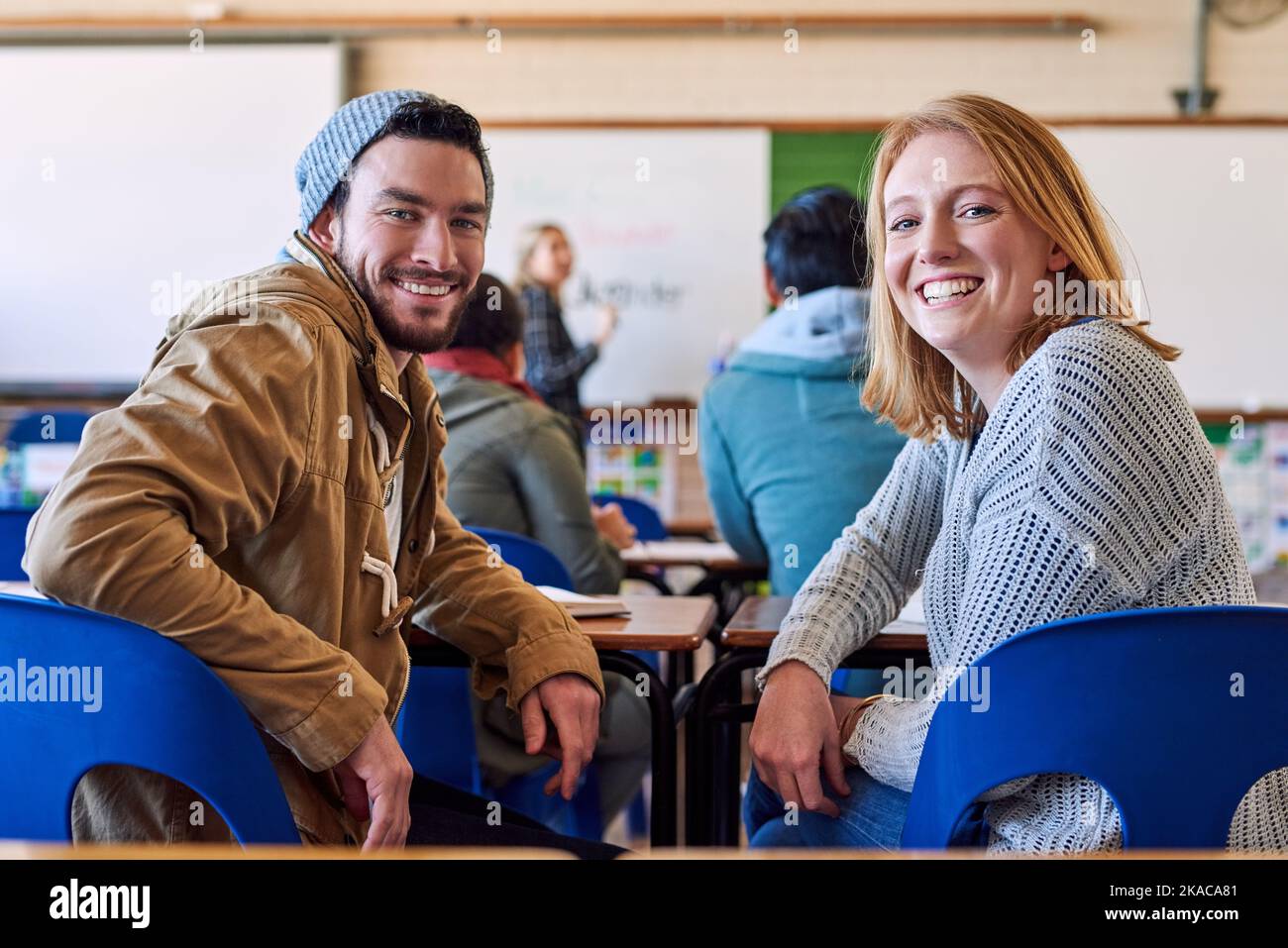 Education is a must. Rearview portrait of two young university students sitting in class during a lecture. Stock Photo
