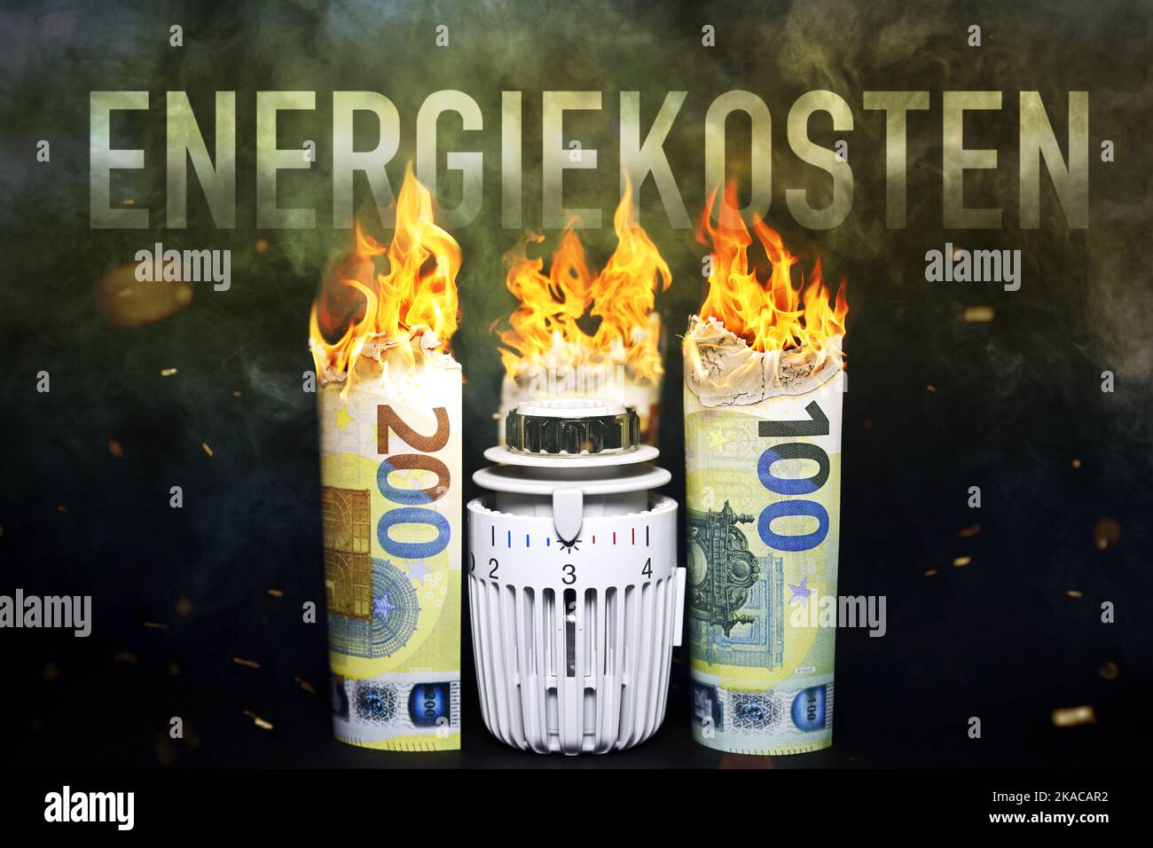 FOTOMONTAGE, Heizungsthermostat zwischen brennenden Euroscheinen und der Schriftzug Energiekosten Stock Photo