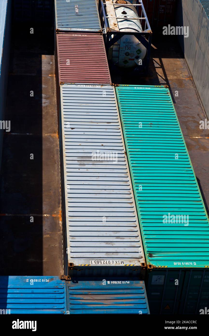 ship on river transports container in belly Stock Photo