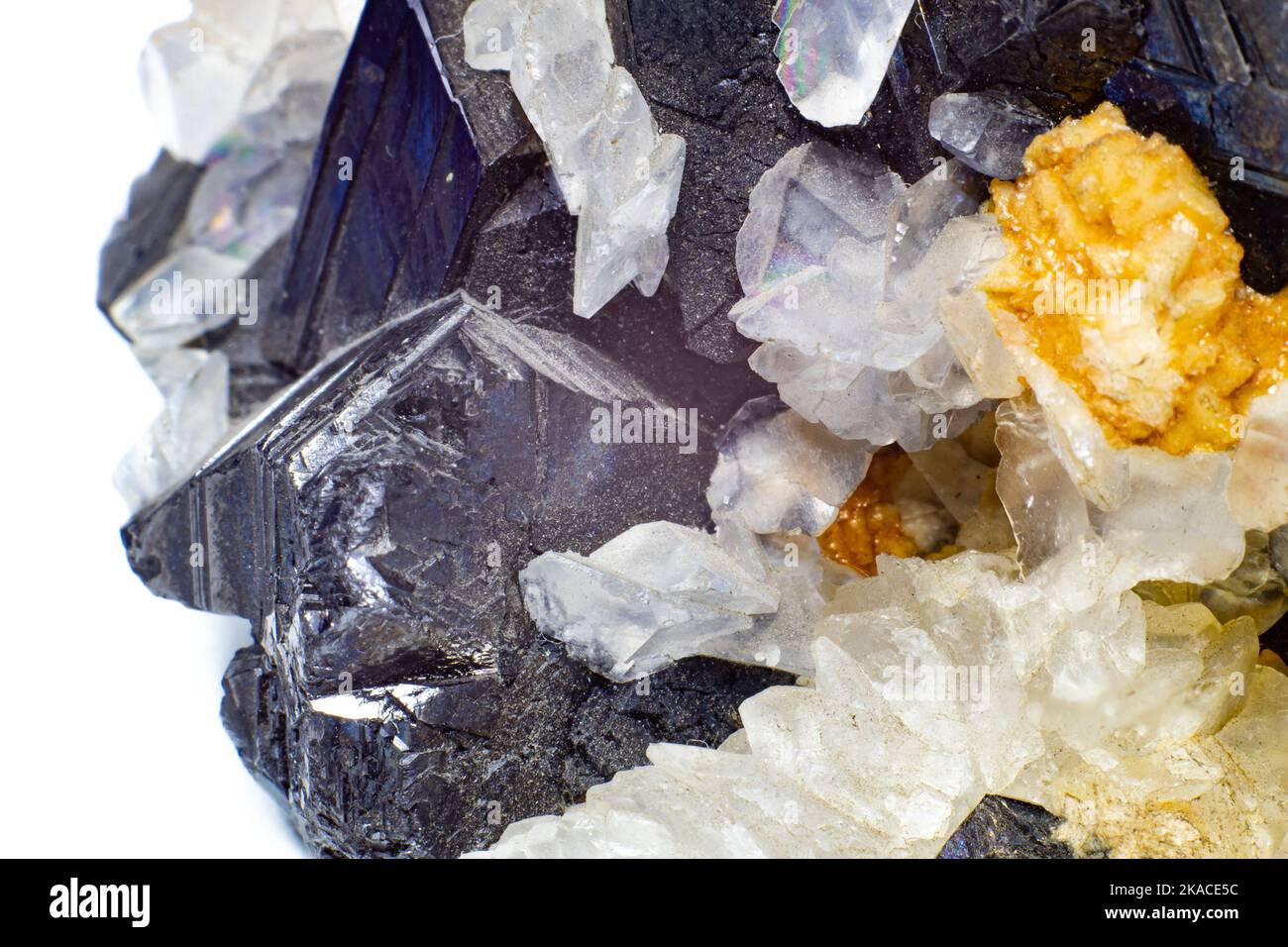 A crystal and stone cluster with clear white quartz, silver metallic pyrite and black matrix macro close up isolated on a white Stock Photo