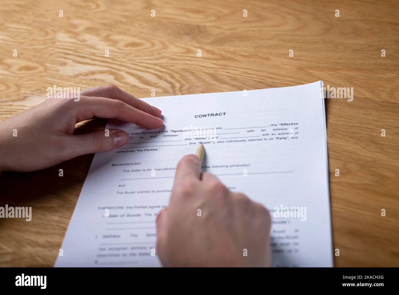Paper sales contract on office desk in hands with pen, pov. Stock Photo