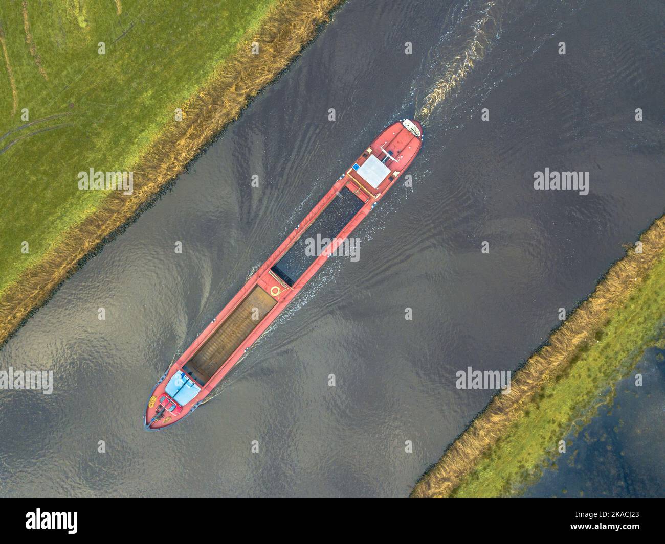 Moving Inland freight ship Aerial top down view  in dutch canal Stock Photo