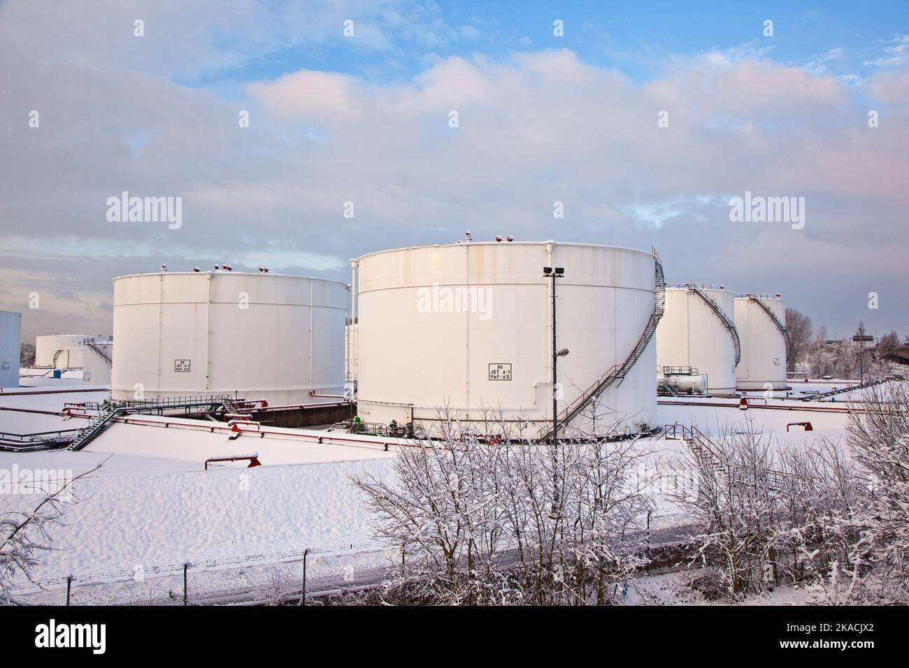 white tanks in tank farm with iron staircase in snow Stock Photo Alamy