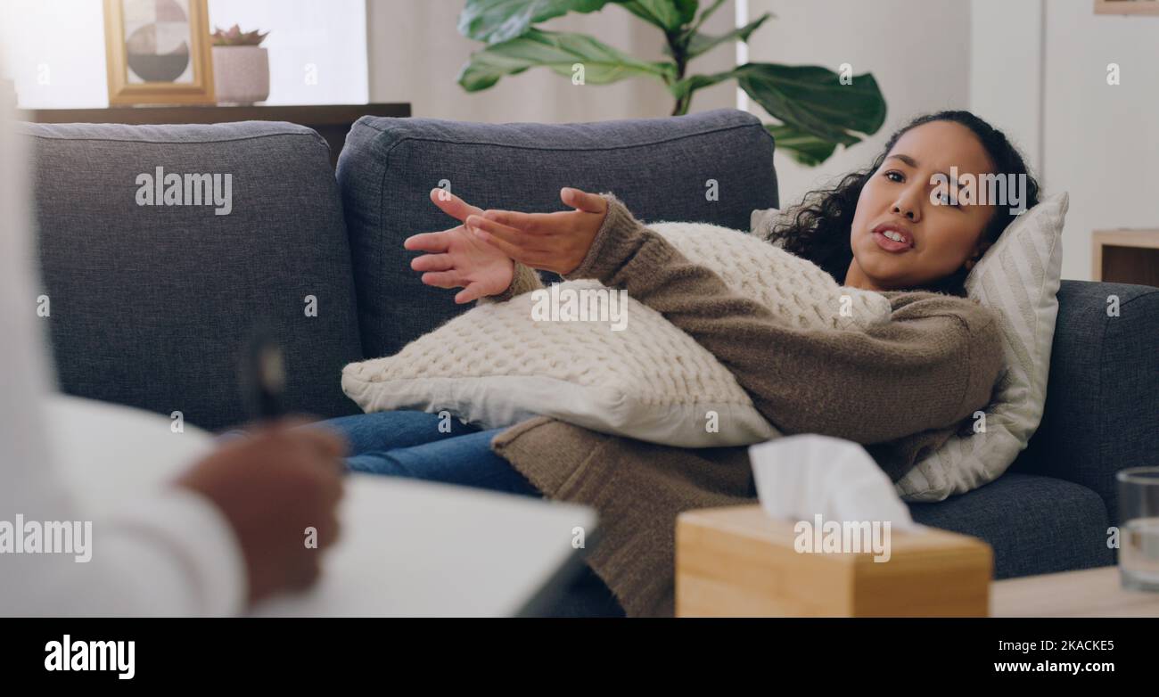 Woman on sofa consulting psychologist for mental health therapy