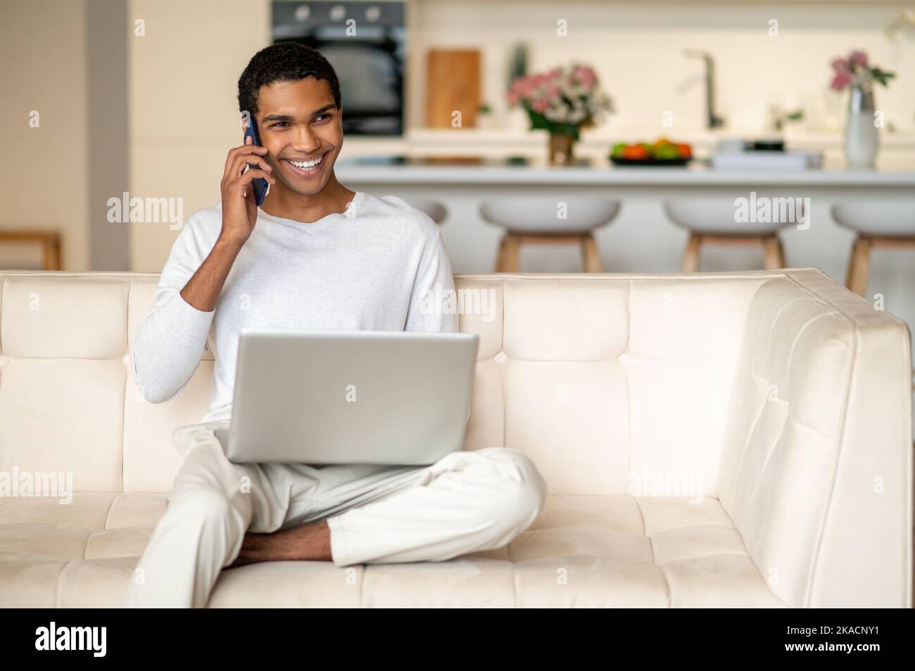 Young handsome dark-skinned man with a laptop Stock Photo