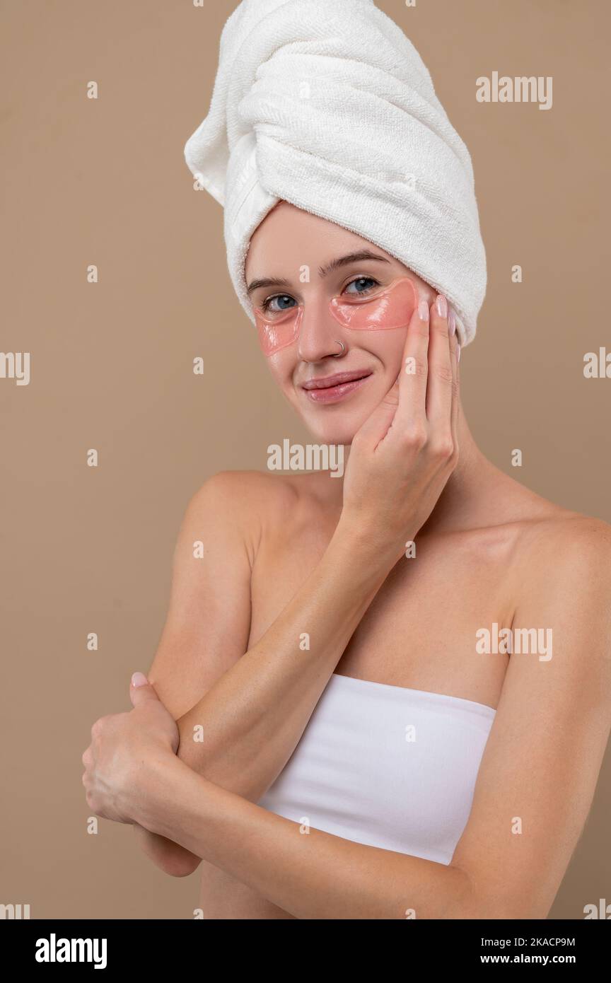 Young girl with towel on head and with patches under eyes Stock Photo