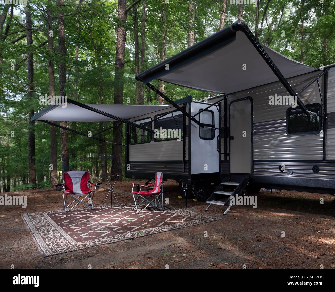 Camper trailer set up with awnings out at a campsite at Jordan Lake