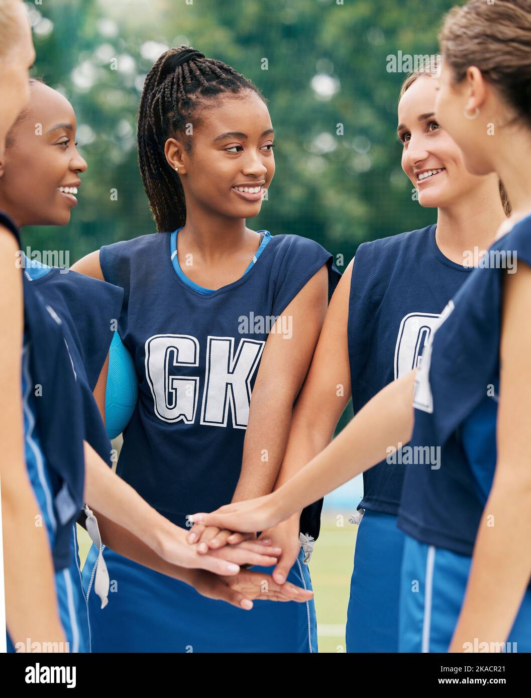 Support, teamwork and sports with netball women for motivation, planning and training on field. Happy, vision and goals with diversity of friends Stock Photo