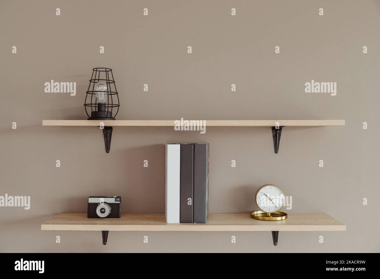 Wall shelves with decor and books in the interior. Modern housing