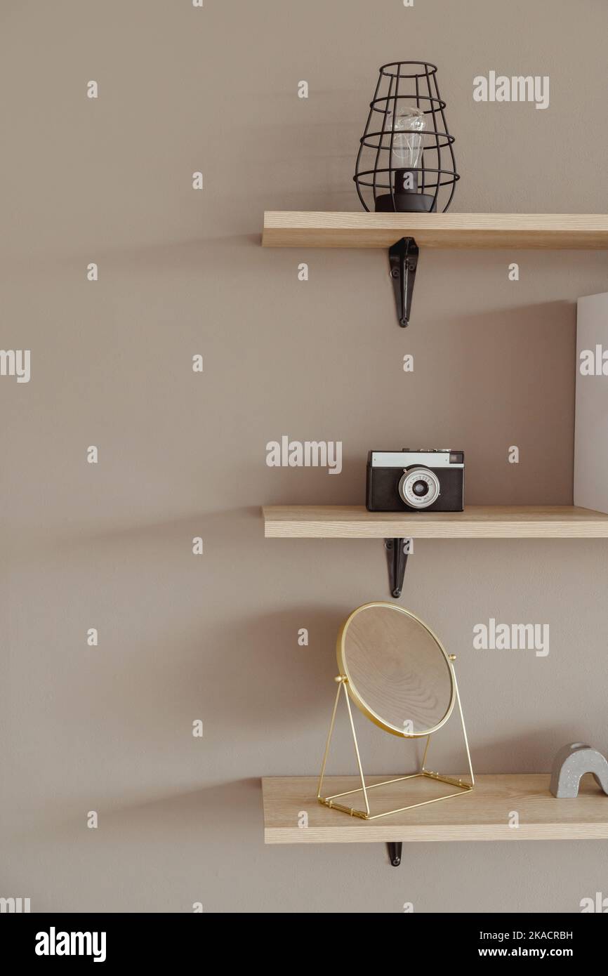 Wall shelves with decor and books in the interior. Modern housing