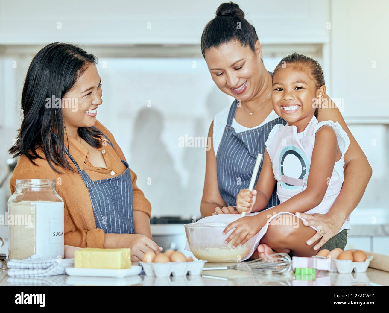 Cooking, kitchen and grandmother teaching child with flour, butter and egg for breakfast, dessert or food and bonding together. Elderly woman, mom and Stock Photo