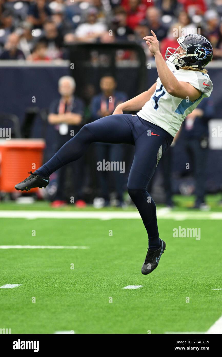 Tennessee Titans punter Ryan Stonehouse (4) is airborne after kicking a punt during the NFL Football Game between the Tennessee Titans and the Houston Stock Photo