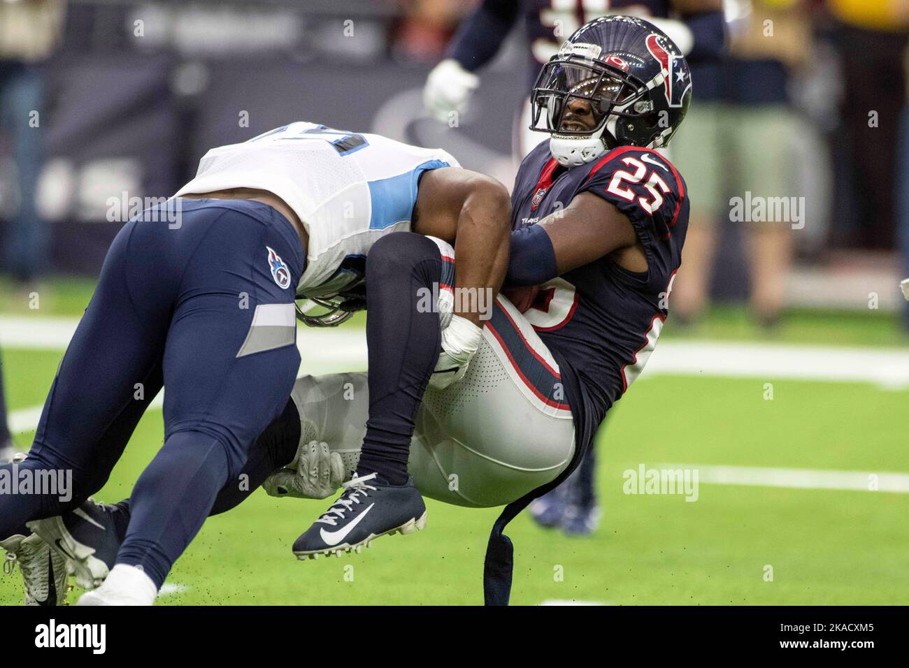 Tennessee Titans running back Hassan Haskins (25) tackles Houston Texans cornerback Desmond King II (25) during the NFL Football Game between the Tenn Stock Photo