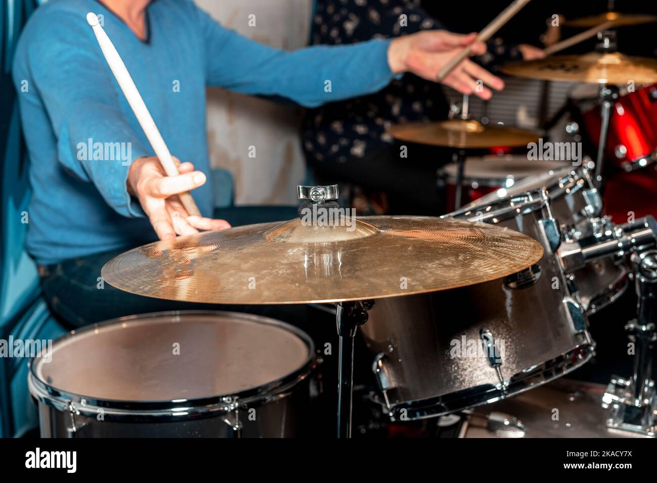 Male drum player hands holding cymbals with both hands and sticks. Drummer. Stock Photo