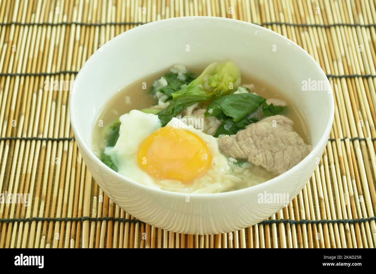 boiled rice with slice fermenting pork and cabbage topping egg yolk on ...