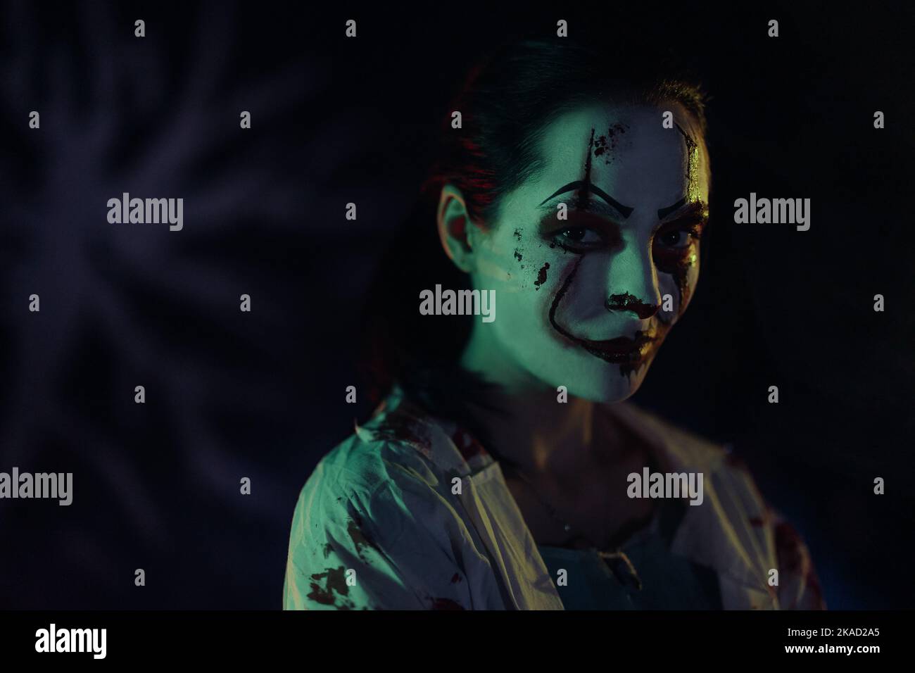 Portrait of young woman in image bloodthirsty zombie with horror wounds