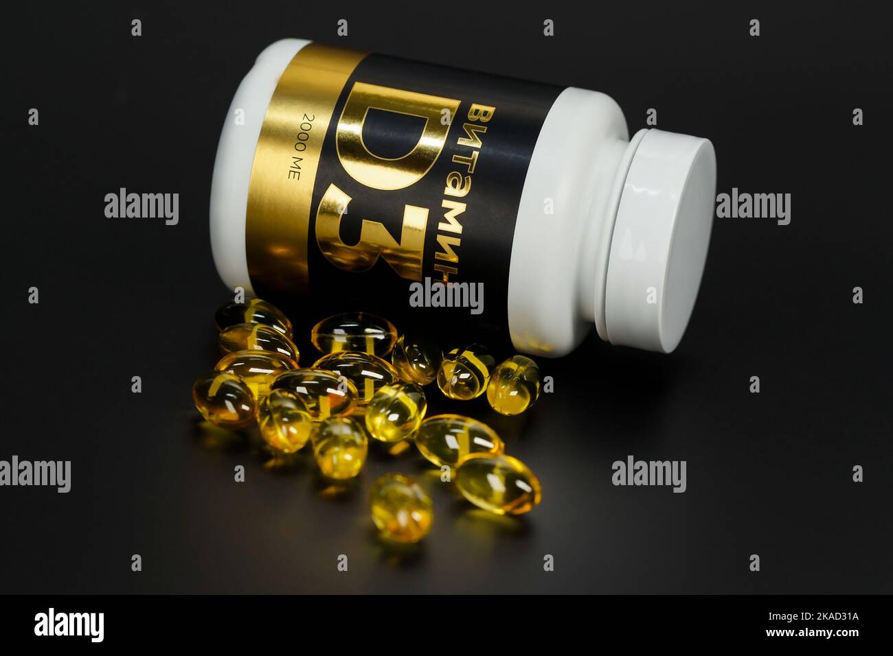 Vitamin D3 capsules, packaging of vitamins, on a dark background with backlight. Macro