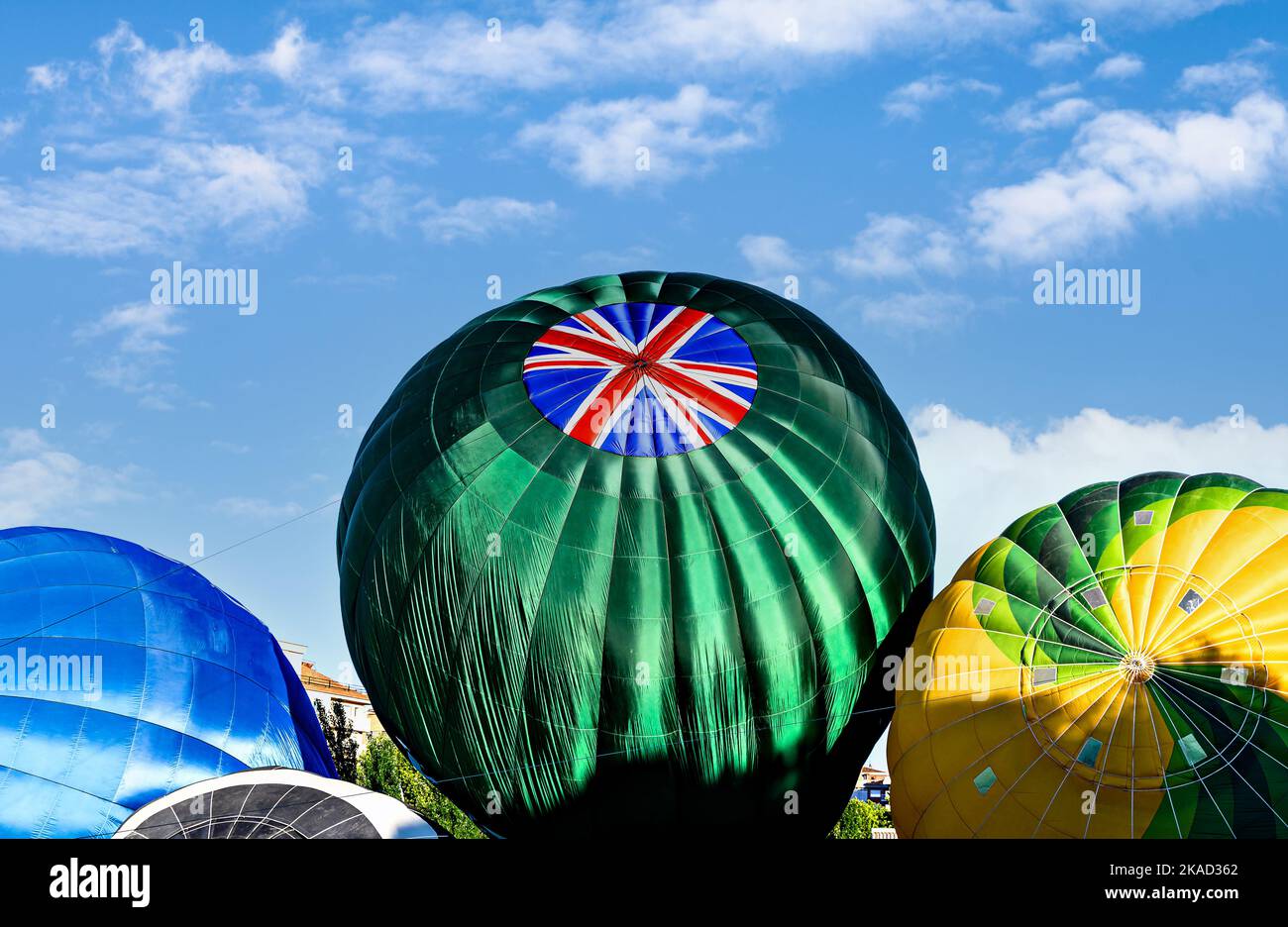 Colorful hot air balloon flying over blue sky Stock Photo - Alamy