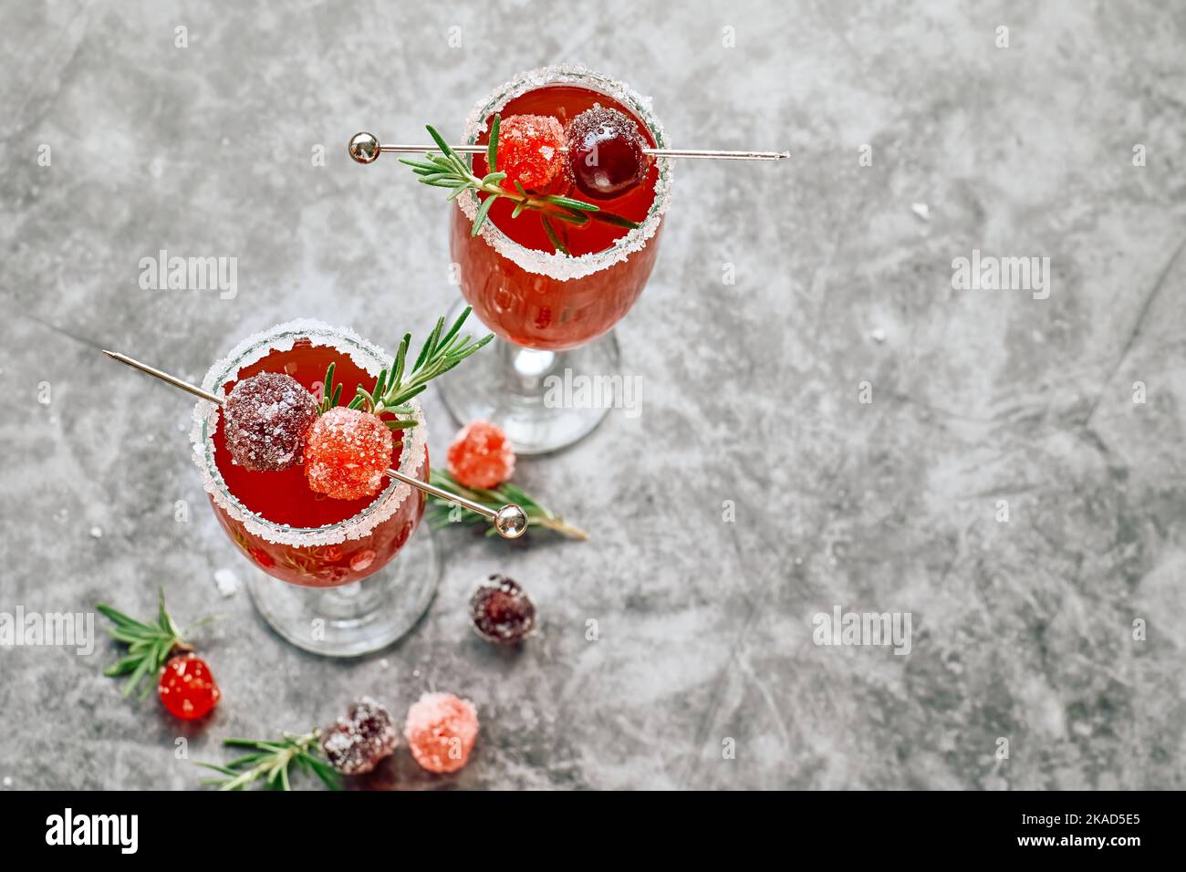Christmas mimosa punch or cranberry margarita cocktail with cranberry juice, orange liqueur and champagne. Delicious icy drink for christmas holiday. Stock Photo