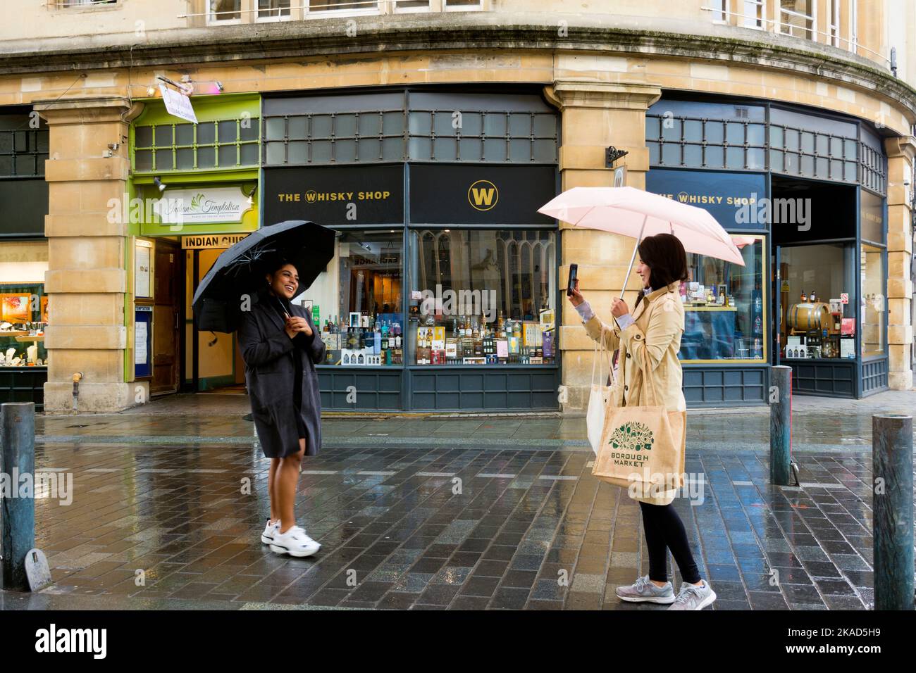 Tourists take phone camera digital photographs in Bath, Somerset, England, UK Stock Photo
