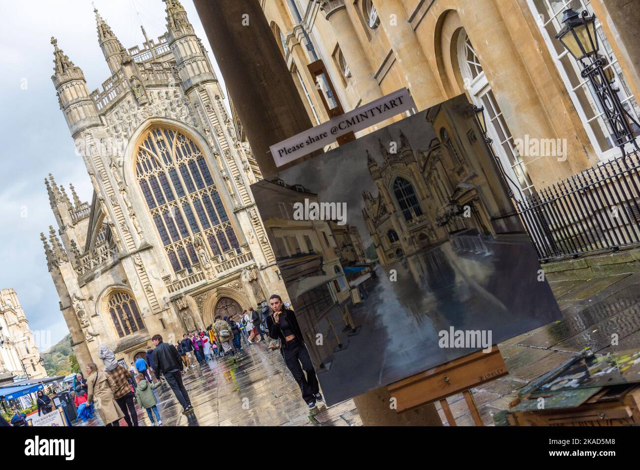 An artist works on his painting of Bath Abbey in Bath, Somerset