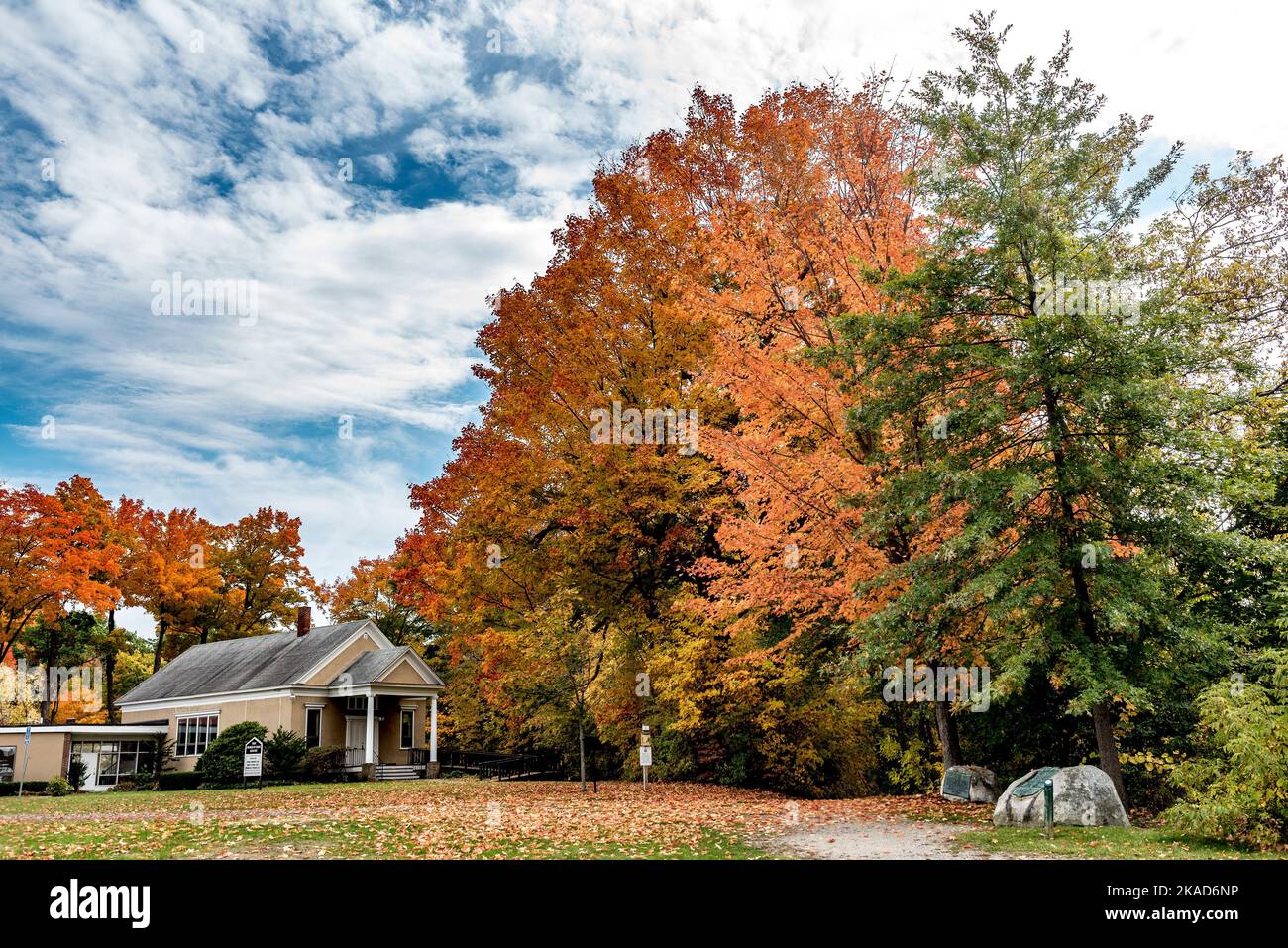 A rural area next to a forest in New England in autumn with bright ...