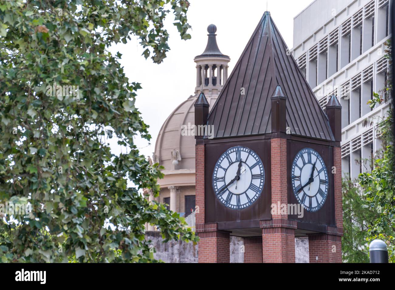 A clock tower building in Downtown Houston, Texas in daylight Stock