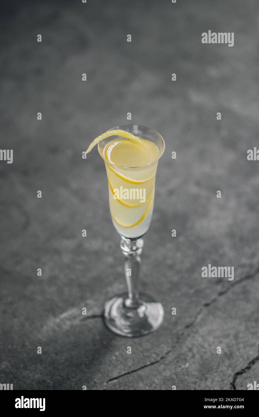 french 75 champagne cocktail with lemon twist garnish in flute glass