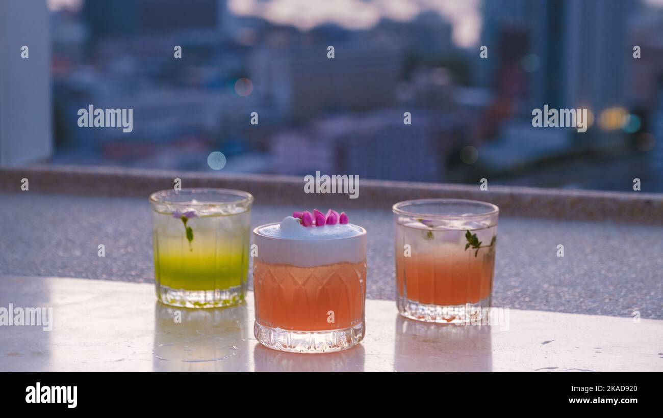 cocktail drinks on a rooftop bar in Pattaya Thailand during sunset