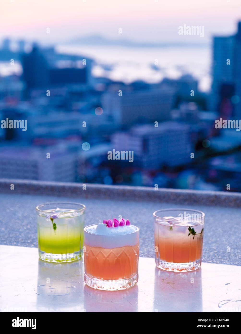 cocktail drinks on a rooftop bar in Pattaya Thailand during sunset