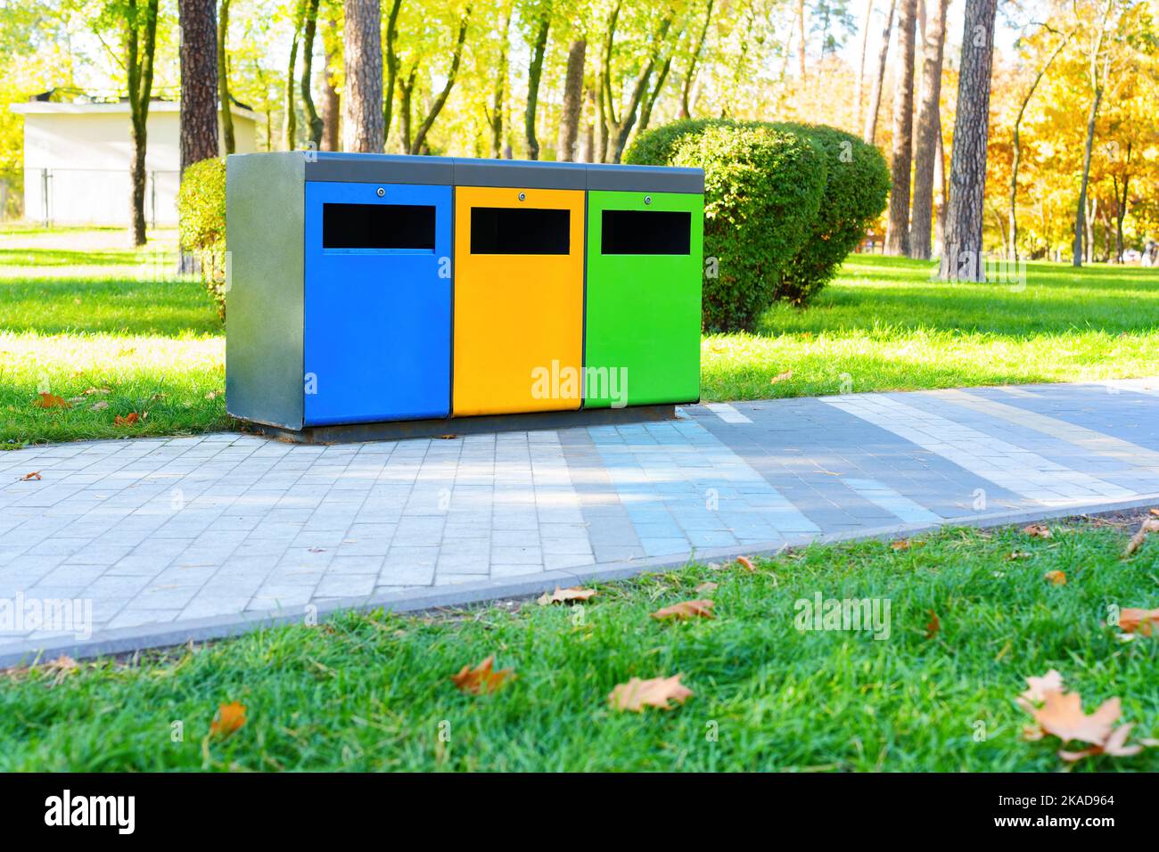 Colored trash bins for waste collection and sorting in a public park on