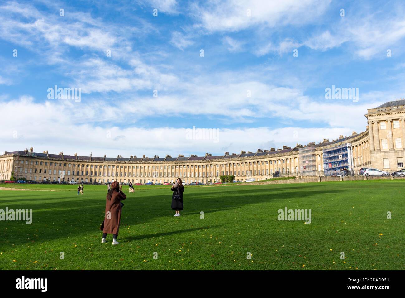 Tourists take phone camera digital photographs in Royal Crescent, Bath, Somerset, England, UK Stock Photo