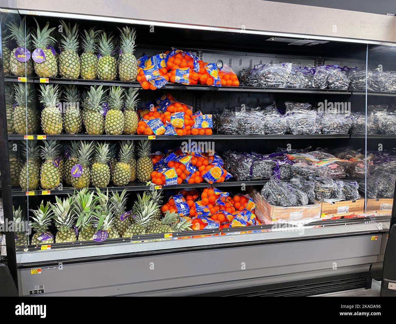 Grovetown, Ga USA - 04 22 22: Retail store food products Walmart produce section fruit display pineapple oranges grapes Stock Photo