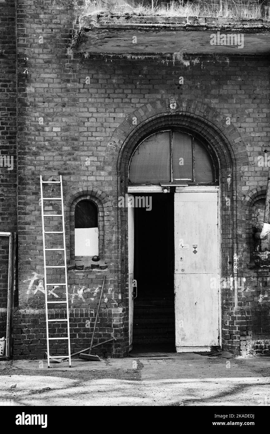 Psych Front Window A vertical black and white shot of the front entrance and ladder of an ...