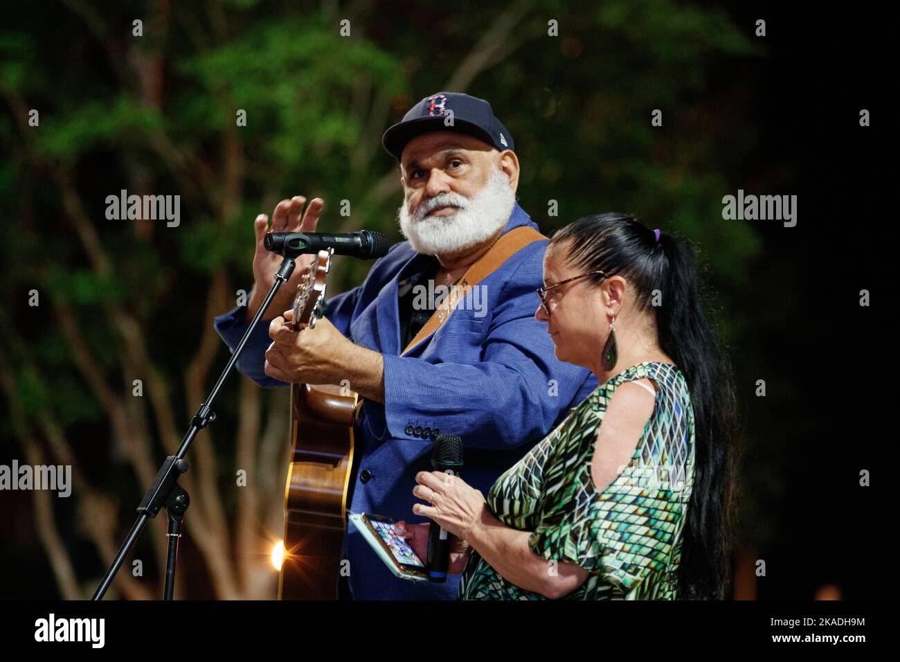 Protesters perform songs to the crowd during a candlelight vigil in