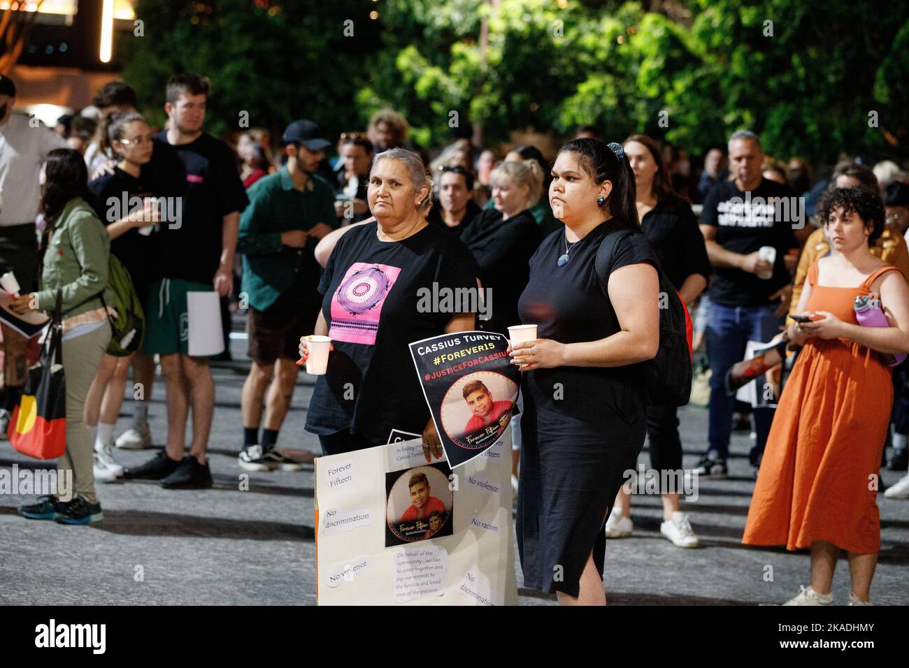 Protesters carry candles and flags during a vigil in Brisbane on 2