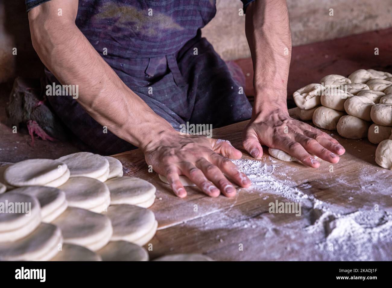 Hands of a man preparing dough for bread in Leh, Ladakh, India Stock Photo