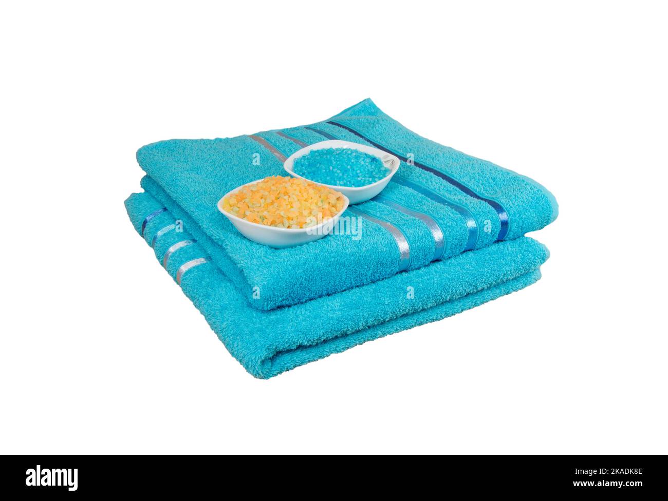sea salt Spa and folded stack of blue towels isolated on white background. Stock Photo