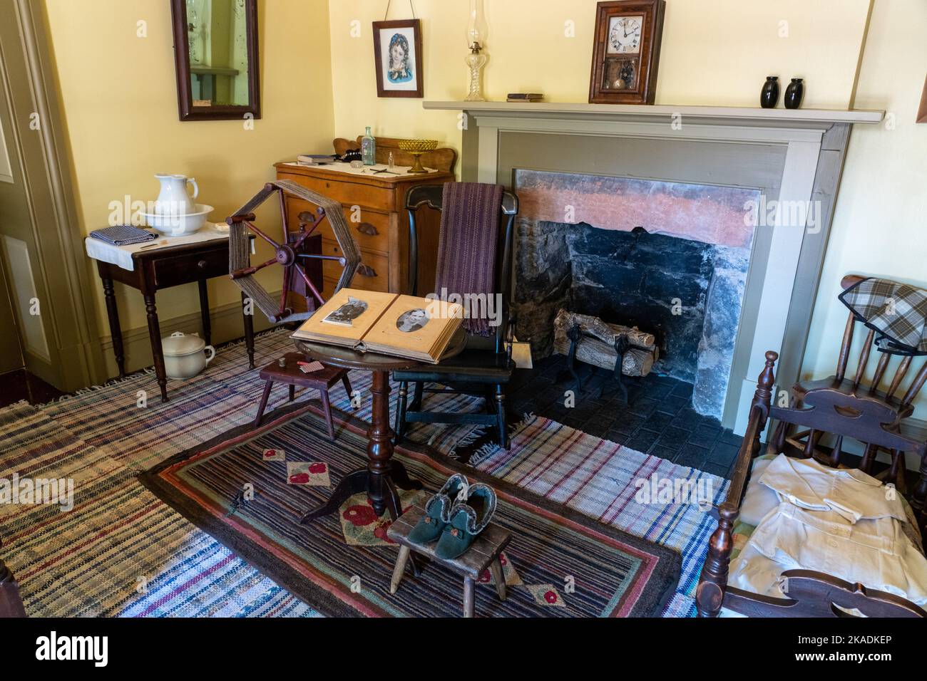 Antique furnishings including a spinning wheel in a lodging room of the