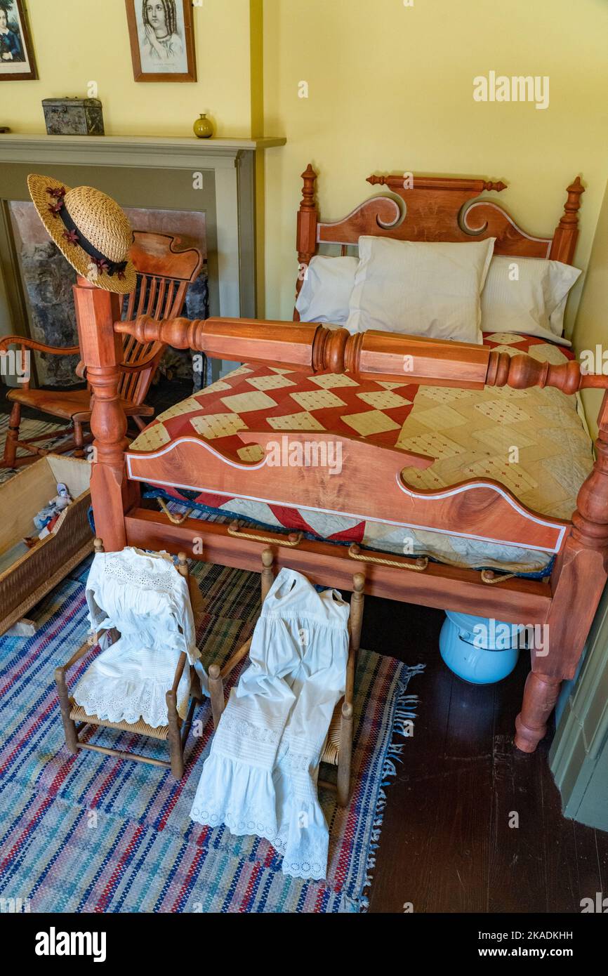 Antique furnishings including children's clothing a lodging room of the