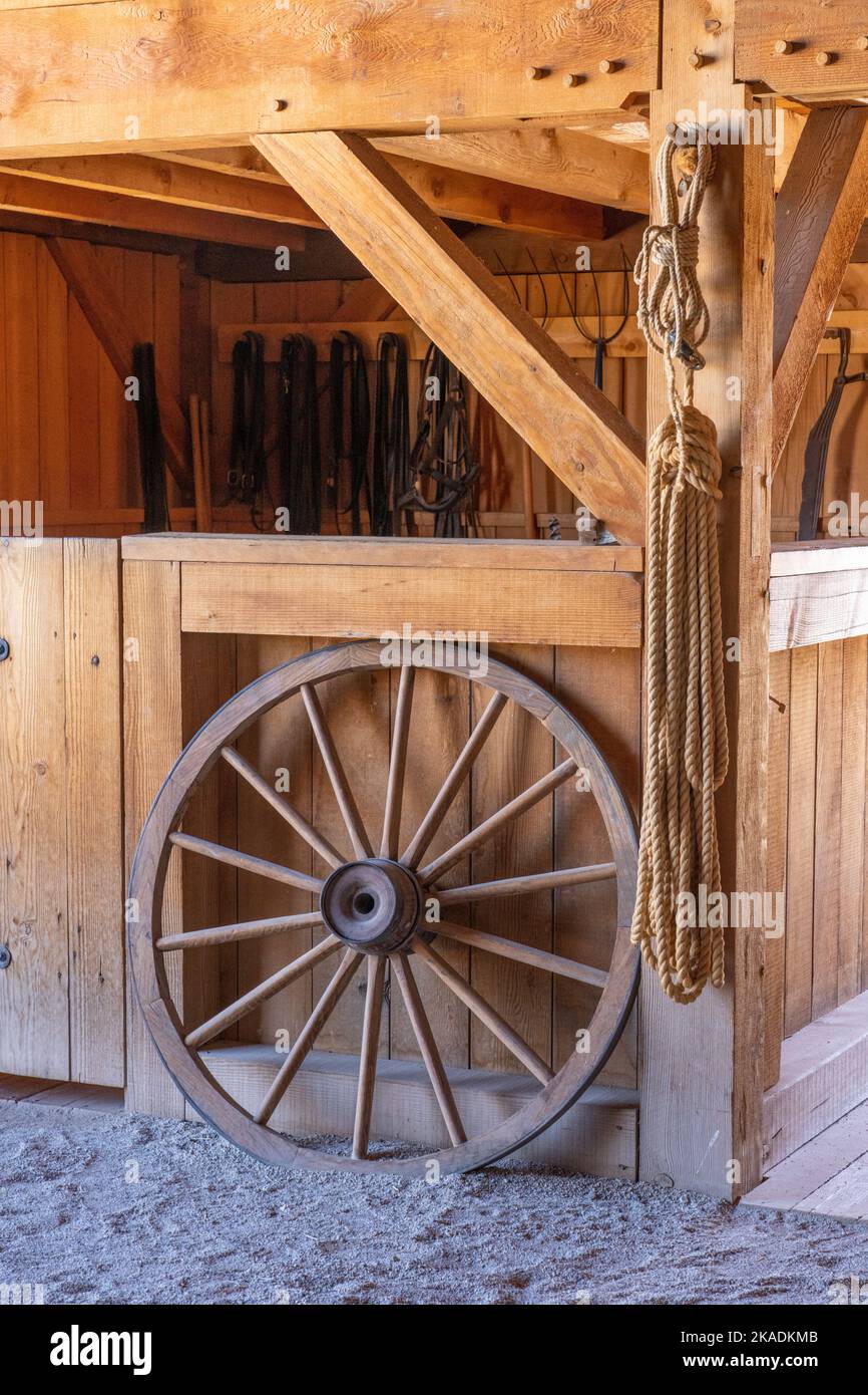 A vintage wagon wheel in the barn of the pioneer Cove Creek Ranch Fort, built in 1867, Cove Fort, Utah. Stock Photo