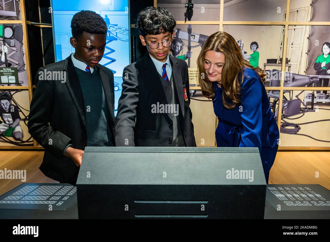 London, UK. 2nd Nov, 2022. Gillian Keegan, Conservative MP for Chichester, Secretary of State for Education helps tsudents as they have a go at controlling the lighting or visual effects in a recreation of the Shuri's Lab film set from Marvel Studios' Black Panther - Technicians: The David Sainsbury Gallery at the Science Museum, ahead of the public opening on Thursday 3 November. Credit: Guy Bell/Alamy Live News Stock Photo