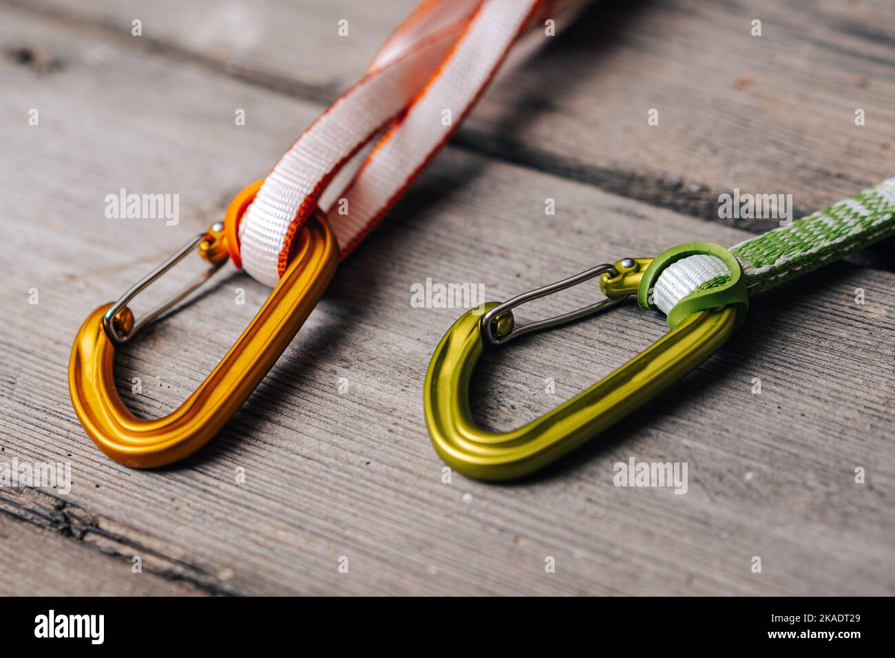 Close up detail photo of carabiners and slings. Climbing gear or equipment on a wooden